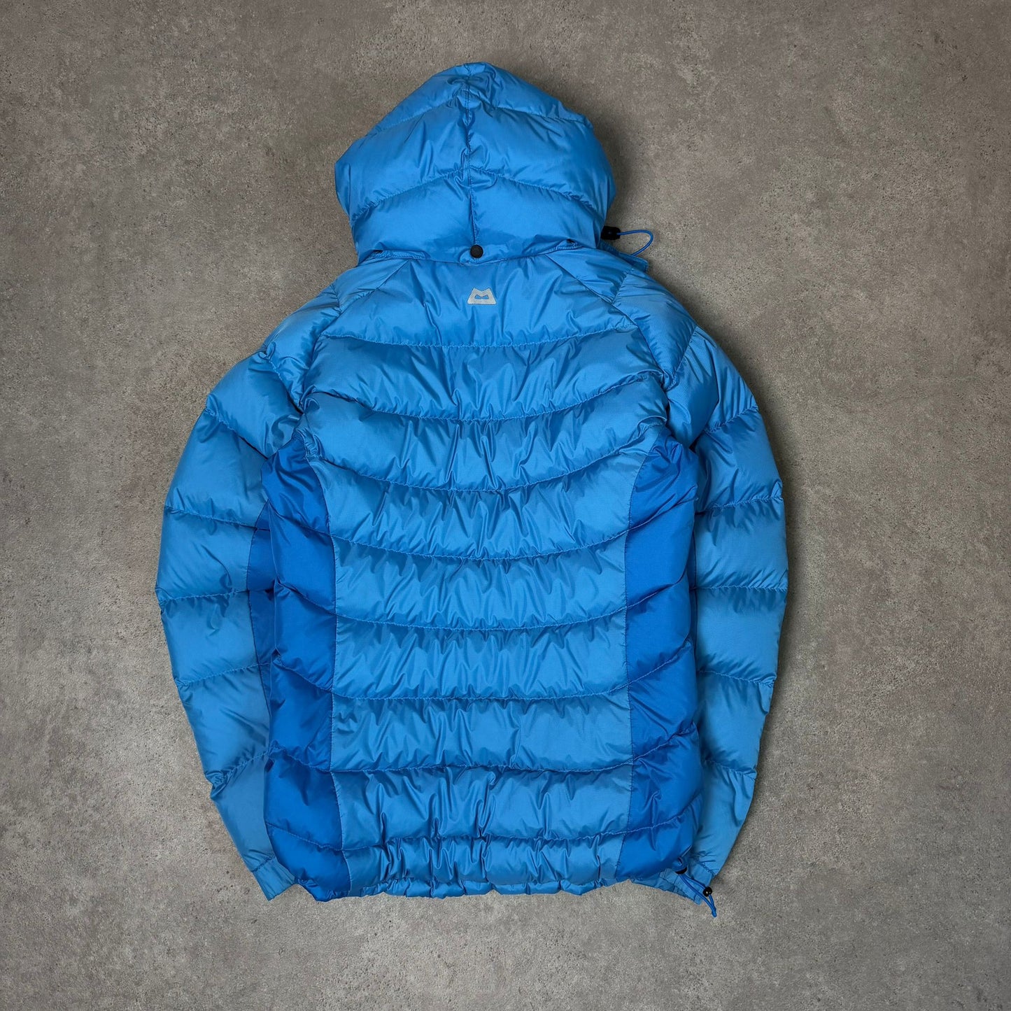 Women's mountain equipment puffer jacket with hood in blue - XS