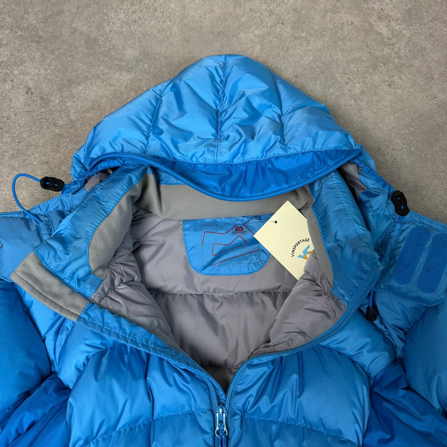 Women's mountain equipment puffer jacket with hood in blue - XS